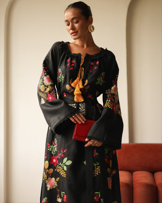 Black floral embroidered linen kaftan maxi dress styled with a red clutch and bell sleeve detail — Zalxndra Resort