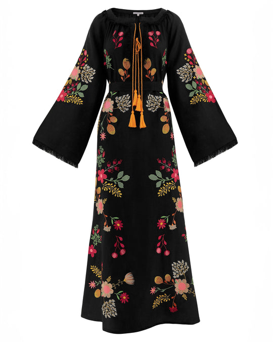 Black embroidered linen kaftan maxi dress with multi-color floral motif and mustard tassel ties shown on white background — Zalxndra Resort