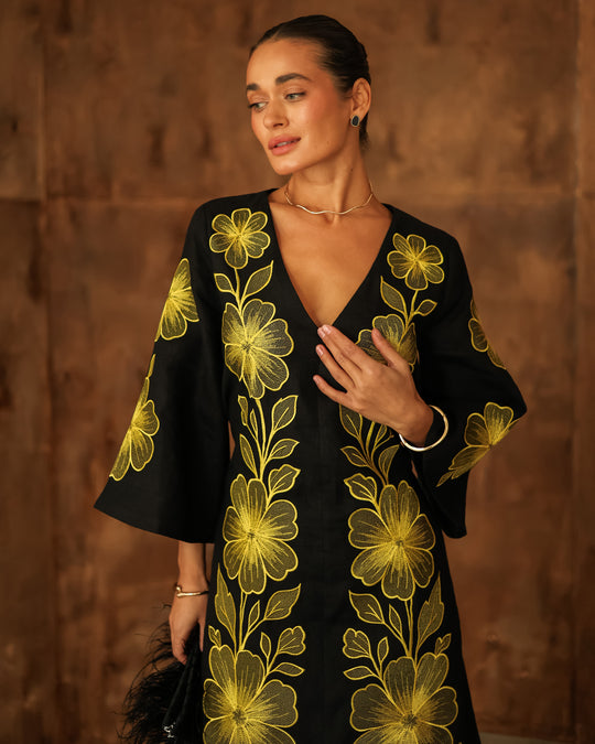 Bodice detail of black linen kaftan maxi dress with V-neck and bold gold floral embroidery - Zalxndra Resort
