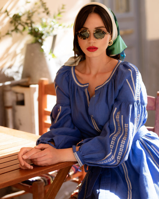 French blue linen kaftan maxi dress with white embroidery and balloon sleeves, styled with green silk headscarf and sunglasses, lifestyle view - Zalxndra Resort
