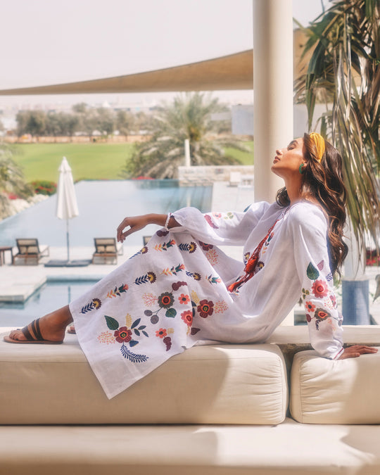 White linen kaftan maxi dress with multicolour folk floral embroidery, balloon sleeves, tassel ties, and side pockets, styled poolside - Zalxndra Resort