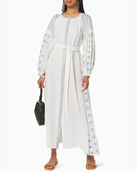 White linen kaftan maxi dress with slate geometric embroidery, balloon sleeves, button closure and self-tie belt, styled with green handbag - Zalxndra Resort