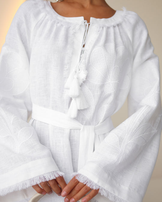 Bodice detail of white linen kaftan maxi dress with tonal floral embroidery, frayed bell sleeves, and tassel ties - Zalxndra Resort